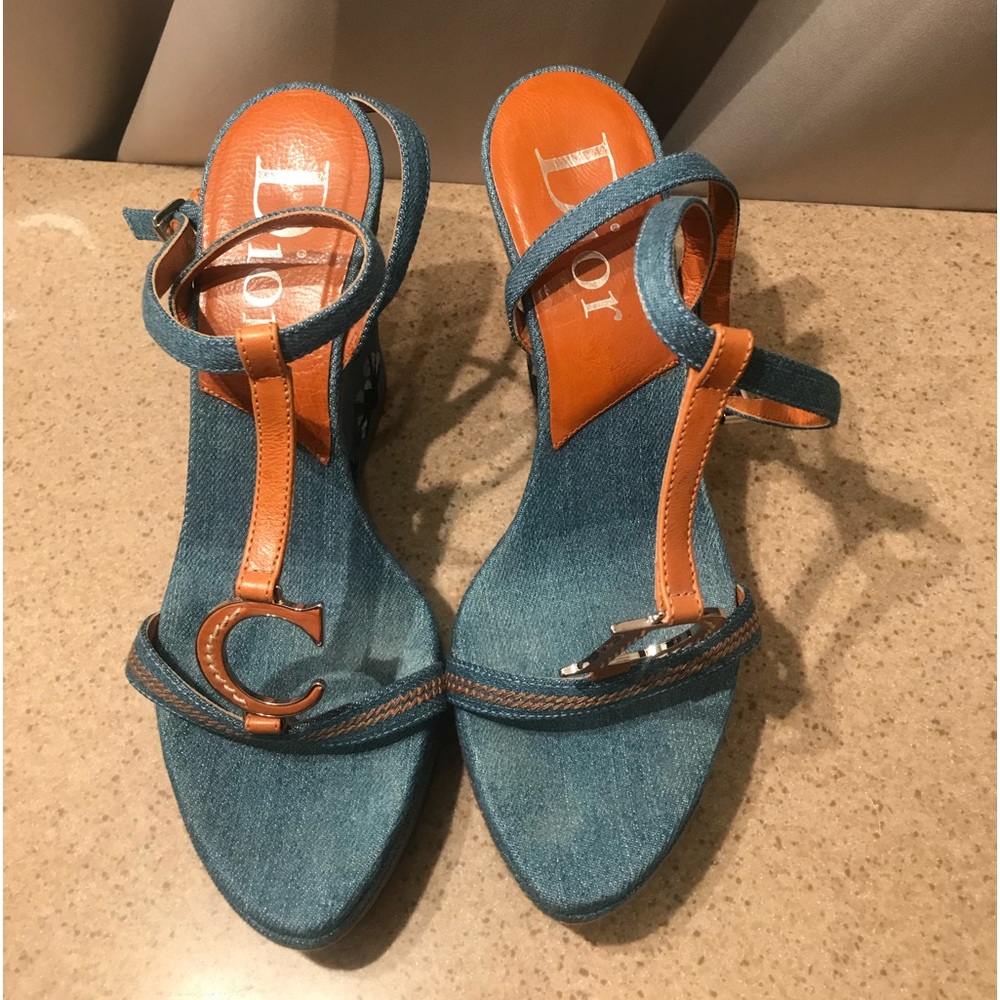 Dior denim open toe wedges with white floral accents.